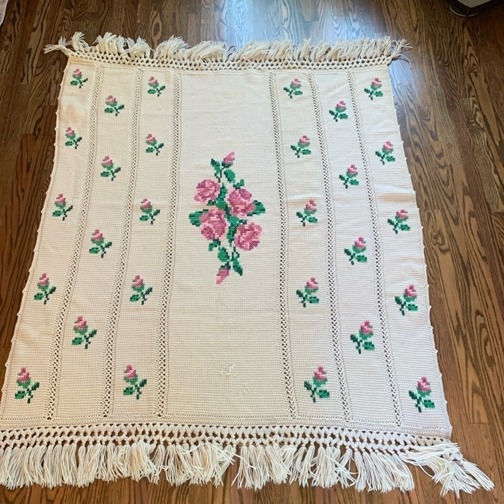 Vintage handmade cream colored afghan with cross-stitch rose design